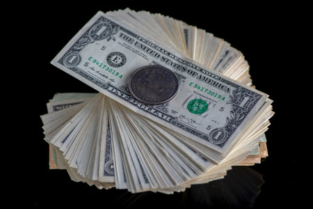 A lot of American dollars banknotes on a dark background.の写真素材