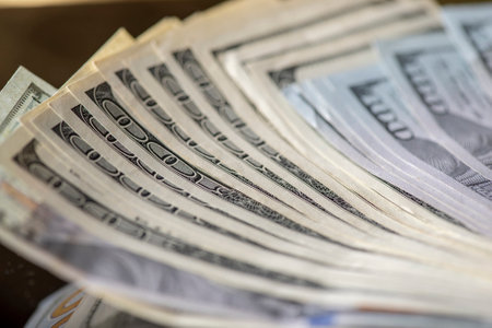 A lot of American dollars banknotes on a dark background.の写真素材