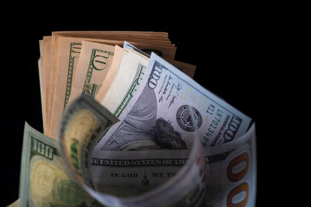 A lot of American dollars banknotes on a dark background.の写真素材