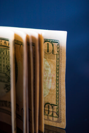 A lot of American dollars banknotes on a dark background.の写真素材