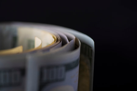 A lot of American dollars banknotes on a dark background.の写真素材