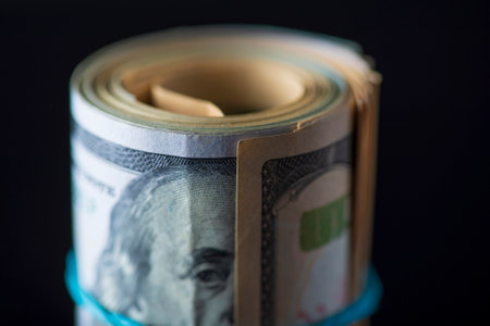 A lot of American dollars banknotes on a dark background.の写真素材