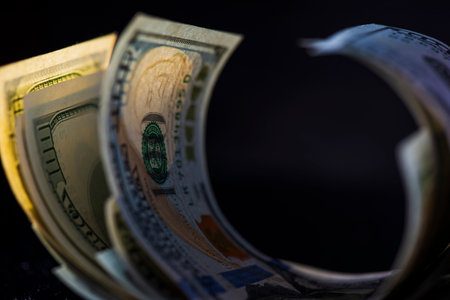 A lot of American dollars banknotes on a dark background.の写真素材