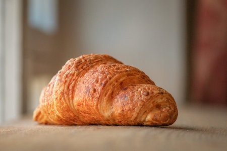 Delicious fresh homemade croissant on a wooden background.の写真素材