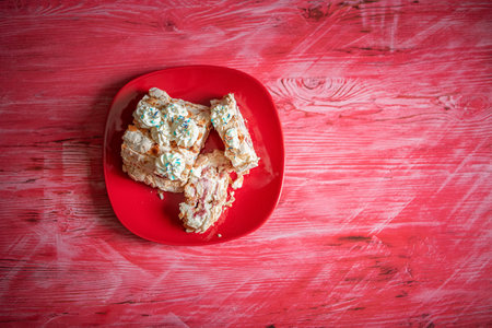 A piece of delicious organic homemade biscuit cake, on a wooden background close-up.