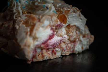 A piece of delicious organic homemade biscuit cake, on a wooden background close-up.の写真素材
