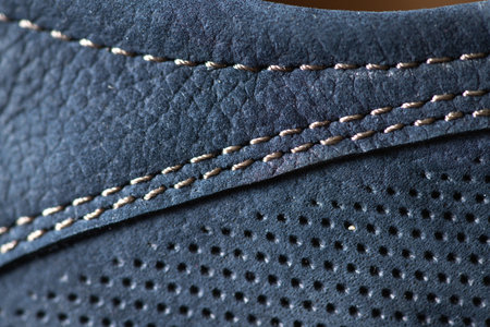 Fragment of men's moccasins made of blue leather close-up. There is artistic blur and artistic noise.の写真素材