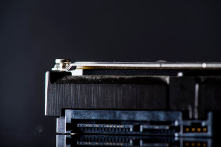 Close-up of a computer hard disk drive on a black backgroundの写真素材