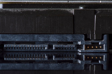 Component parts of a disassembled hard drive, close-up on a dark background.の写真素材