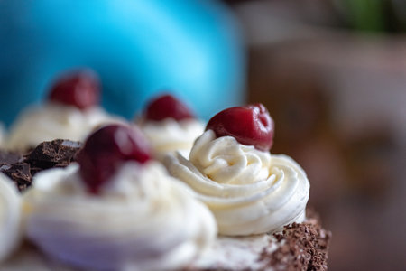 Black forest cherry cake close-up. Sponge cake with chocolate and cherries.