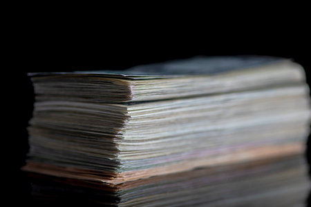 A bundle of banknotes on a dark background. Photographed close-up.の写真素材