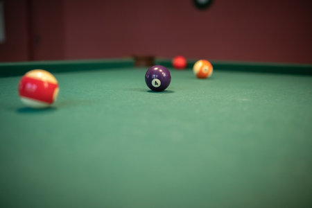 Beautiful green billiard table and balls for playing billiards.