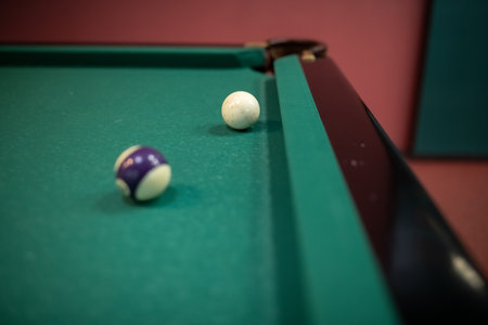 Beautiful green billiard table and balls for playing billiards.
