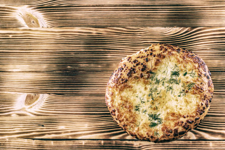 Ciabatta with cheese, garlic and dill on a wooden background.の写真素材