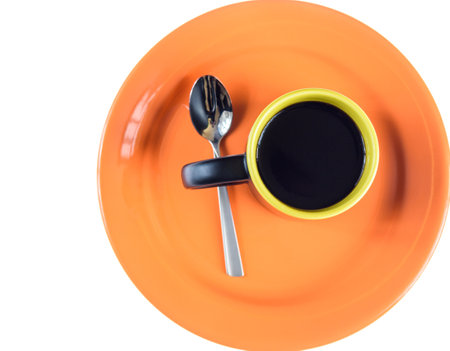 A mug of tea on an orange dish isolated.