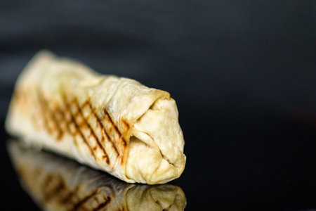 Shawarma with chicken and cabbage on a dark background.の写真素材