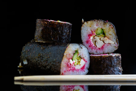Sushi rolls on a black mirror background.の写真素材