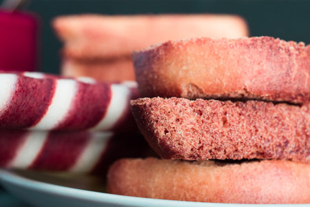 Closeup of a stack of pink and white cookies on a plate