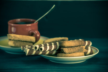 Cup of coffee with cookies on wooden background. Toned.の写真素材