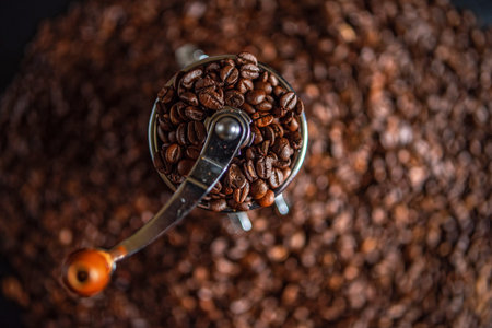 Coffee beans in a coffee grinder on a dark backgroundの写真素材