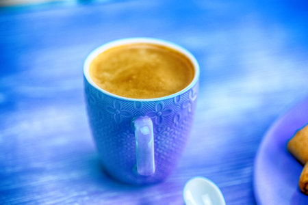 Coffee mug on a blue background.の写真素材