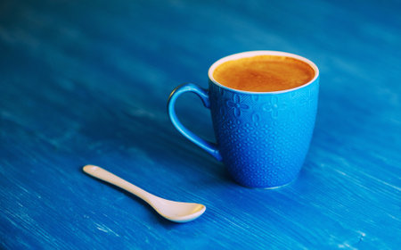 Coffee mug on a blue background.の写真素材