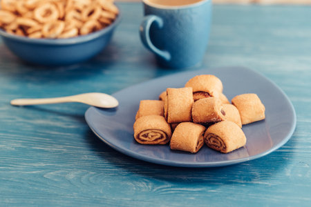 Cookies rolls with jam on a wooden turquoise background.の写真素材