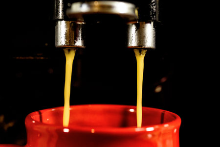coffee pouring from a coffee machine close upの写真素材