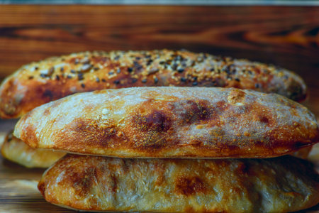 Bread with sesame seeds on a wooden background. Selective focus.