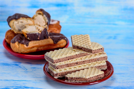 chocolate wafers on a plate on a blue wooden backgroundの写真素材