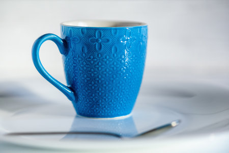 coffee in a blue cup on a light wooden backgroundの写真素材