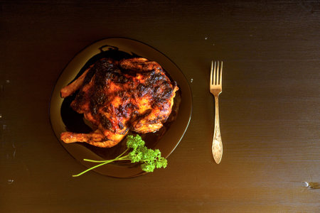 baked chicken on a dark wooden background.の写真素材