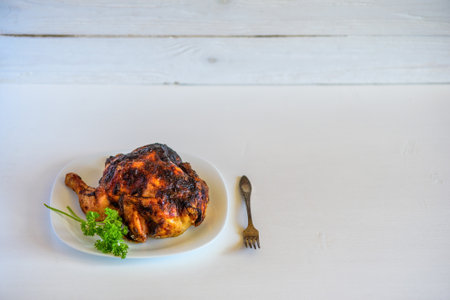 fried chicken on a plate on a light backgroundの写真素材