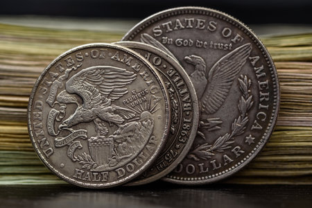 American coins on the background of a stack of dollarsの写真素材