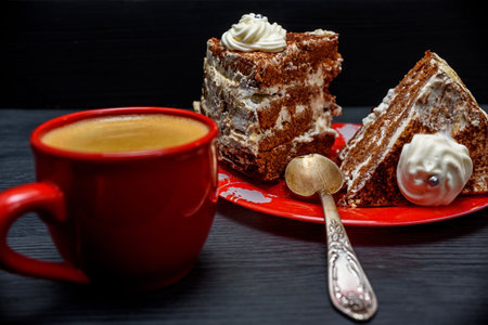 Cup of coffee and cake on a black wooden background. Toned.の写真素材