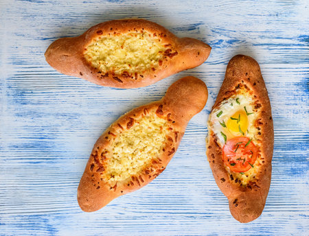 Bread with cheese and tomato on a blue wooden backgroundの写真素材