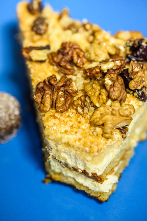 A slice of sponge cake with walnuts close-up.の写真素材
