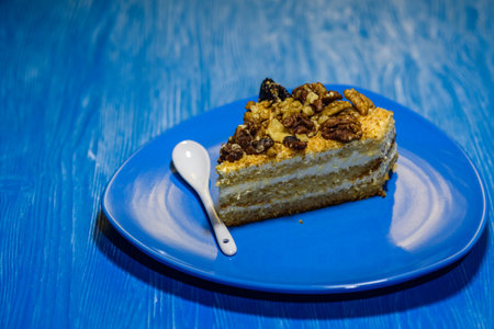 A slice of sponge cake with walnuts close-up.の写真素材