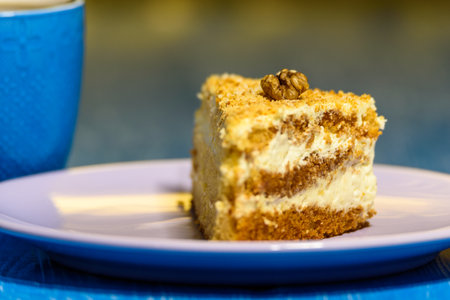 Sponge cake with walnuts, near a cup of coffee.の写真素材