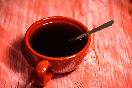 Red Cup with coffee on wooden background.の写真素材