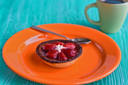 Cake with berries on a plate standing on a wooden background.の写真素材