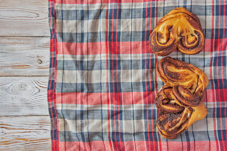 Cinnamon roll on a light wooden background.の写真素材