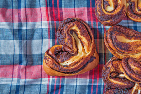 Cinnamon roll on a light wooden background.の写真素材