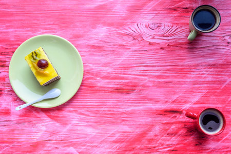 Cake on a ceramic plate standing on a wooden background.の写真素材