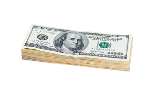 Bundle of hundred dollar bills isolated on white background.の写真素材