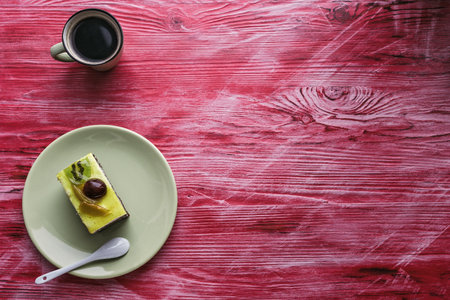 Cake with berries on a ceramic plate standing on a wooden background.の写真素材