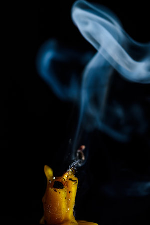 Smoke from a burning candle on a black background, close-upの写真素材