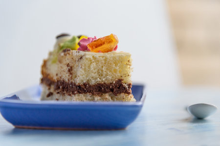 A slice of sponge cake on a rectangular plate.