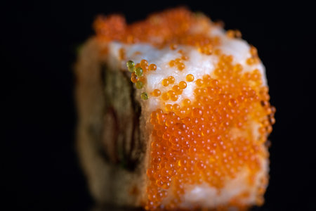 Sushi roll with caviar on a black background close-upの写真素材