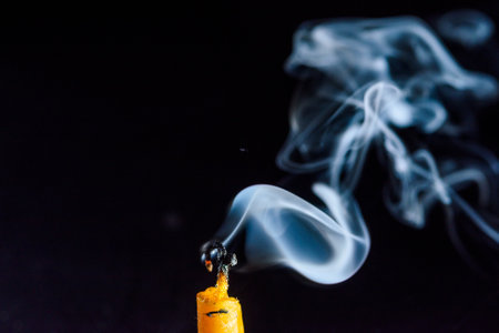 Smoke from a burning candle on a black background. Close-up.の写真素材